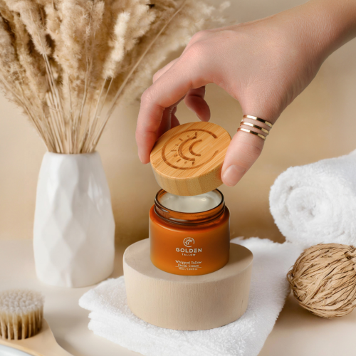 Hand holding a branded golden tallow jar for Logo Design & Branding in Marion, IL